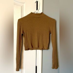 FashionNova crop top with a slight turtle neck in the color Mocha. Size M/L.